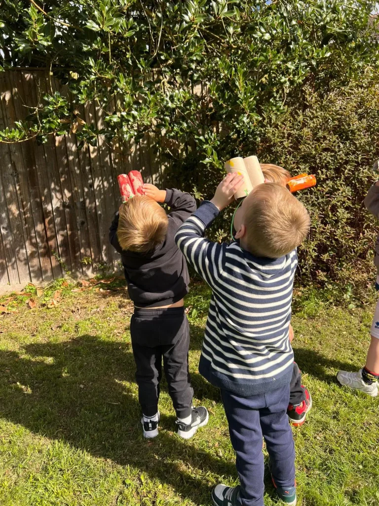 Children Looking Up With Binoculars
